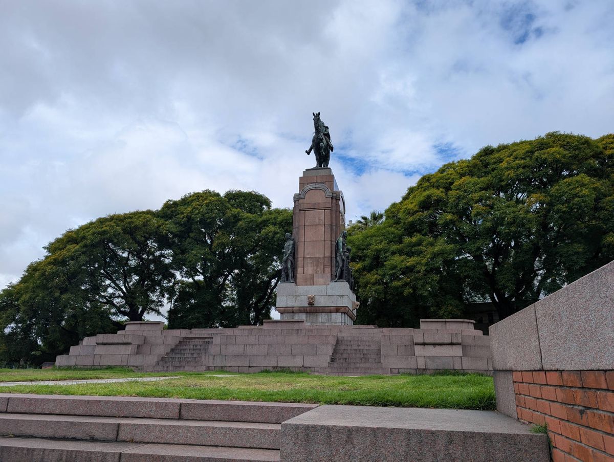 A statue on a tall base above the trees