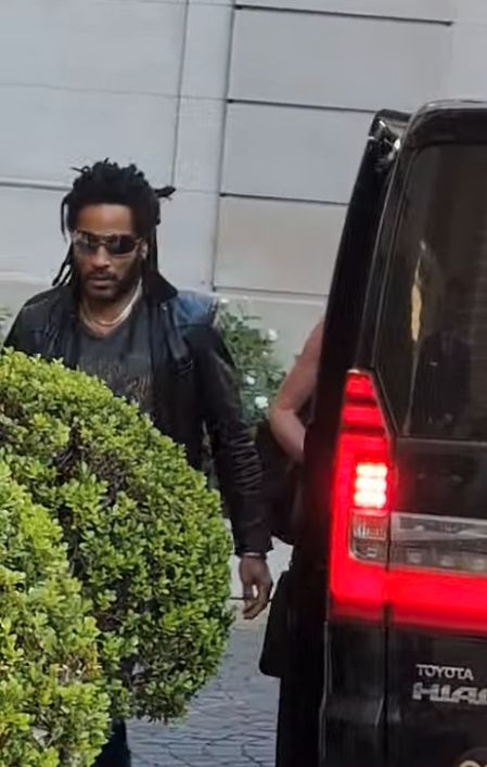 Lenny Kravitz walking to a van outside the hotel