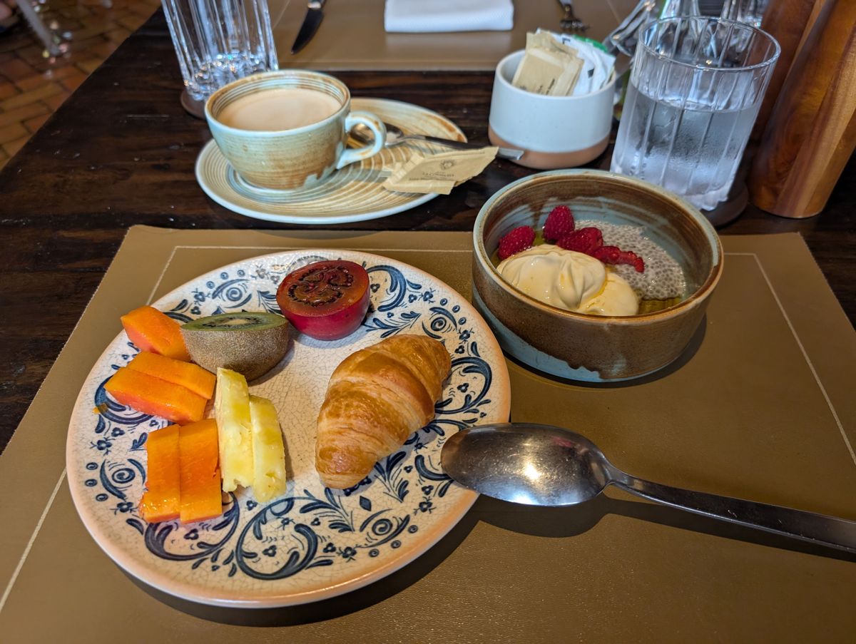 Breakfast: chia pudding, a croissant, papaya and tree tomato