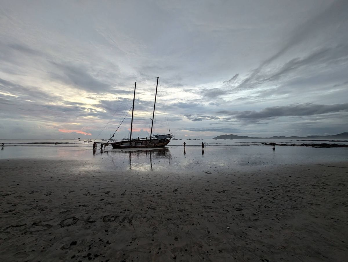 A sailboat on the flats at dusk