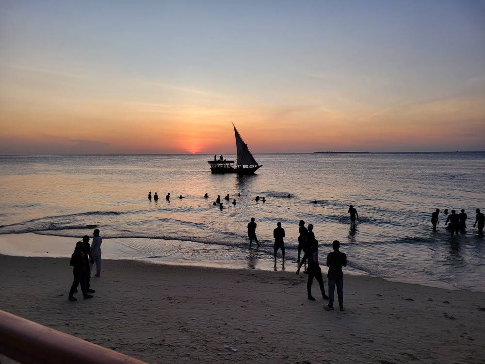 Sunset and a sailboat off Stone Town