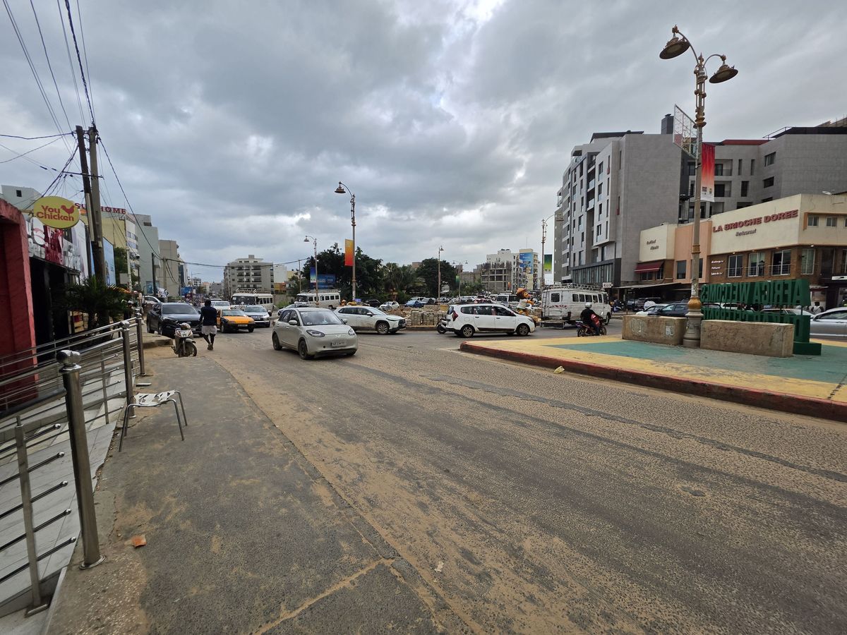 A busy roundabout, with an Africa Welcomes sign on the island