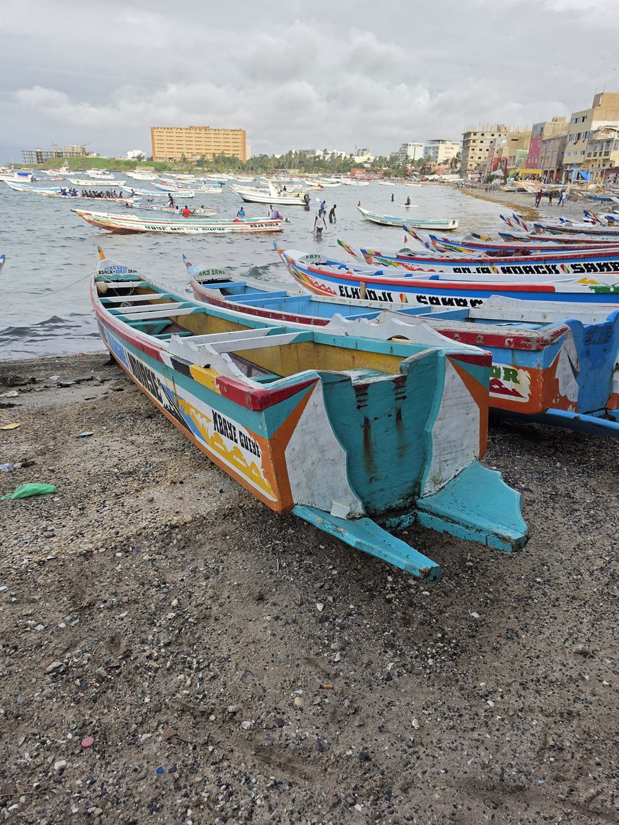 A painted pirogue pulled up on the sand