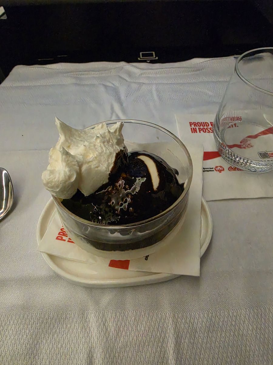 A sundae under a lot of hot fudge