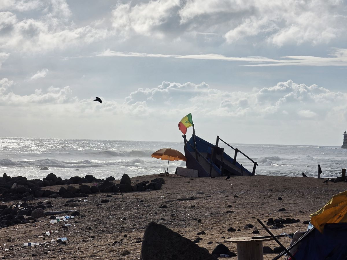 A Senegalese flag over a boat-shaped stand