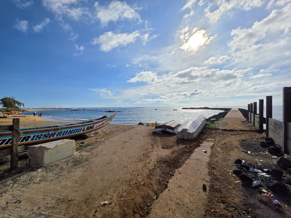 A painted pirogue pulled up by the jetty