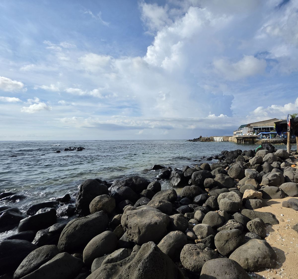 Dark volcanic rocks along the shore