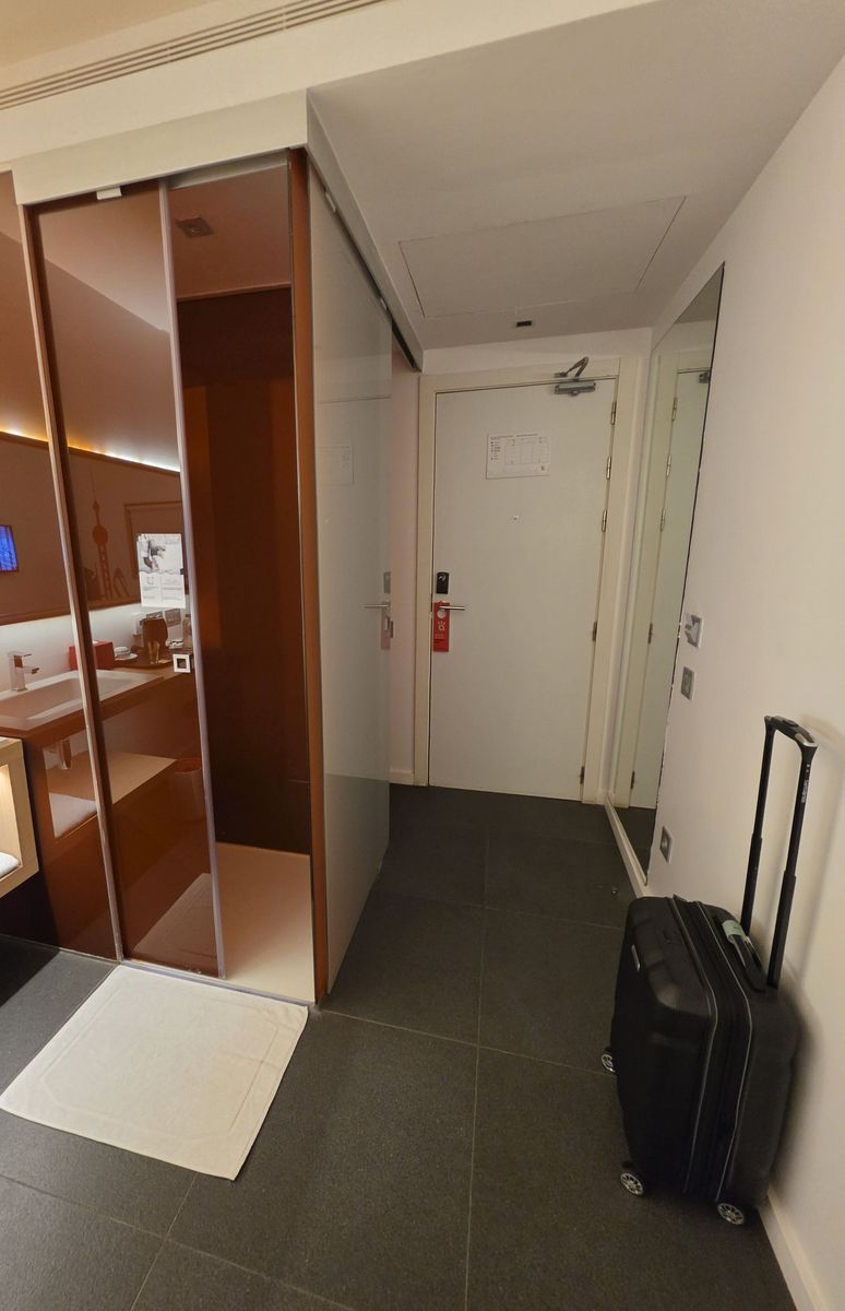 In from the door: the glass shower box on the left, the sink beside it