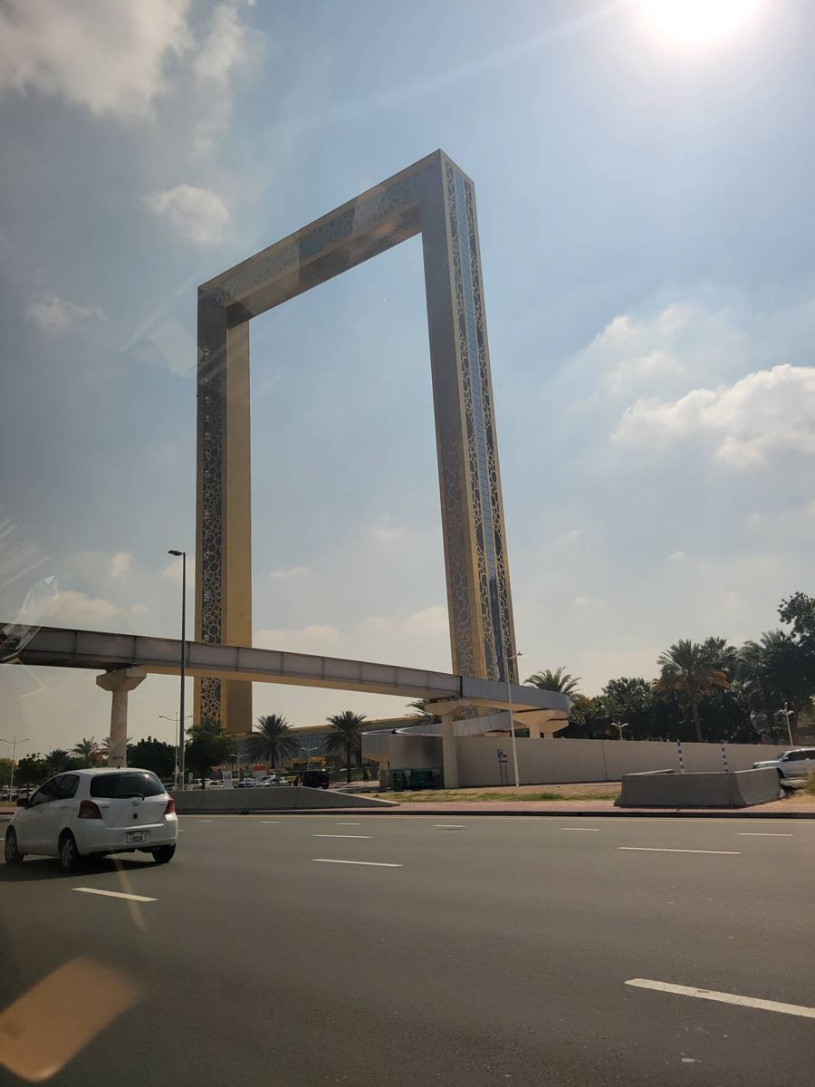 A giant golden picture-frame tower over the road