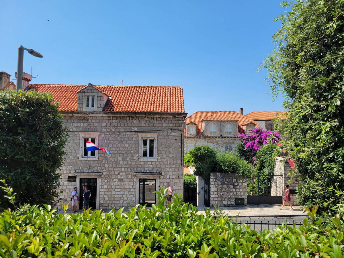 A stone house with a flag