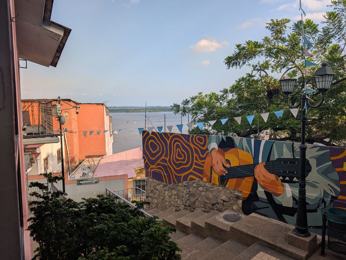 A guitarist mural, with the river behind
