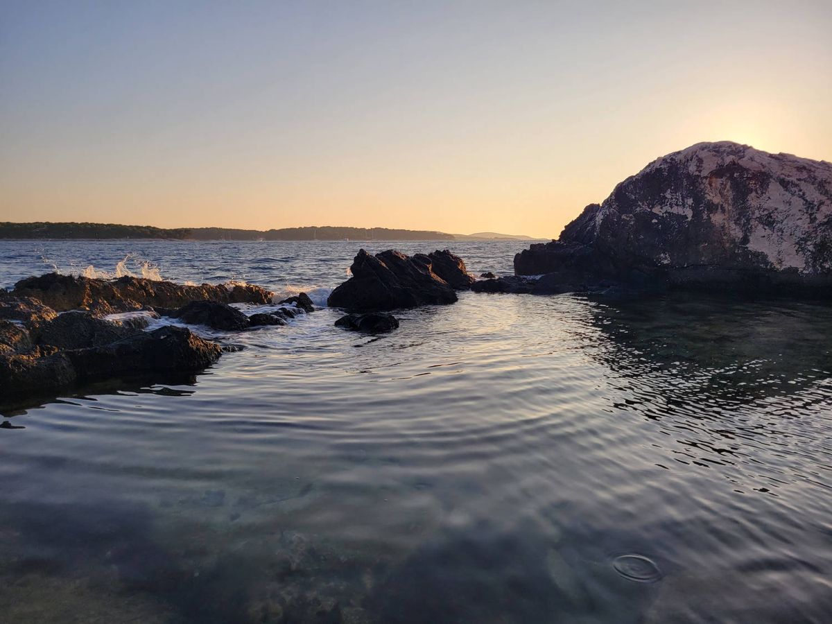 Rocks and still water at sunset