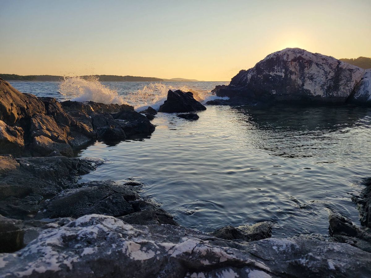 Waves breaking on the rocks at sunset