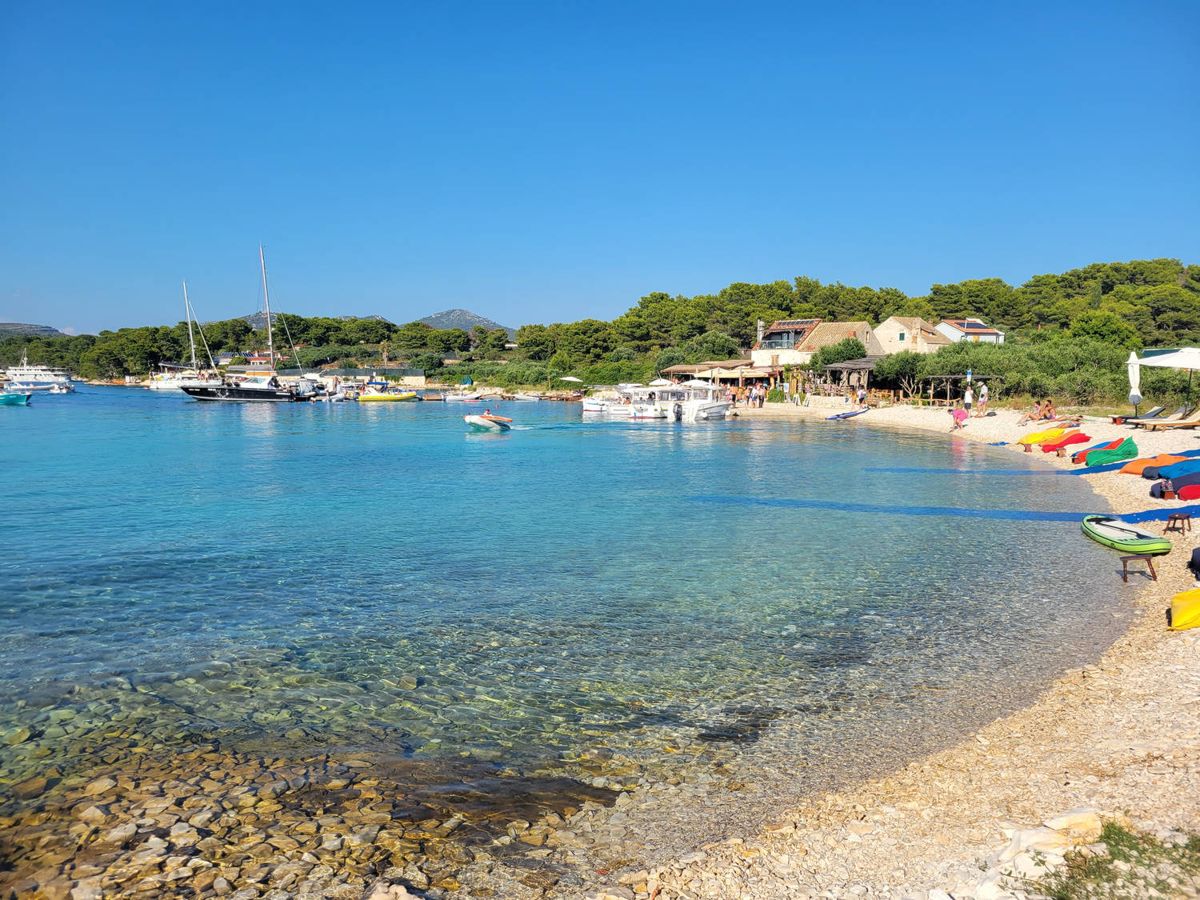 A pebble beach and a cove full of boats