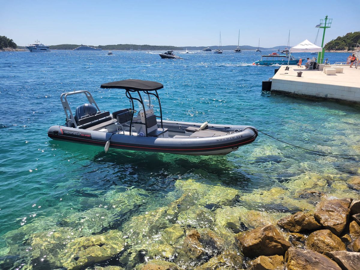 A boat on clear water by a pier