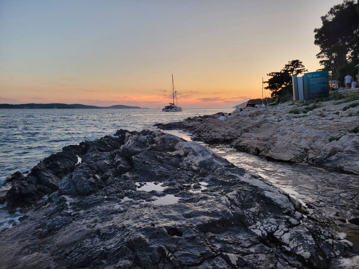 A sailboat and the rocks at sunset