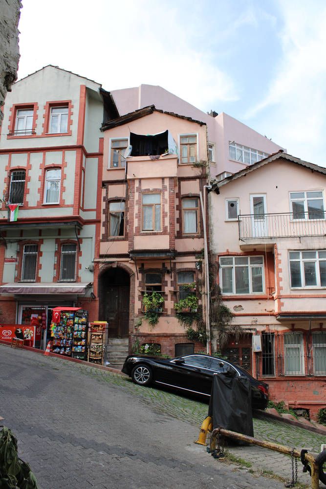 Pink and red row houses on a slope