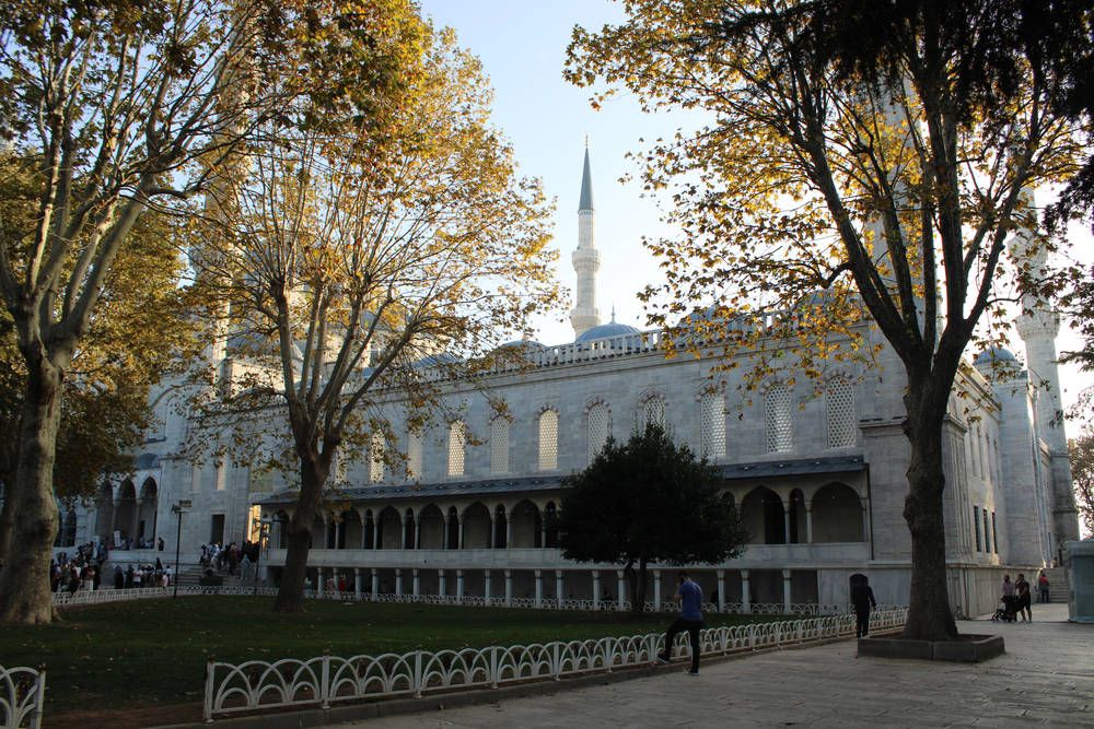 A mosque courtyard under autumn trees