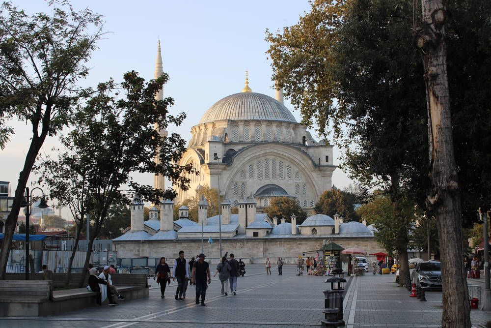 A mosque at the end of a plaza in late light