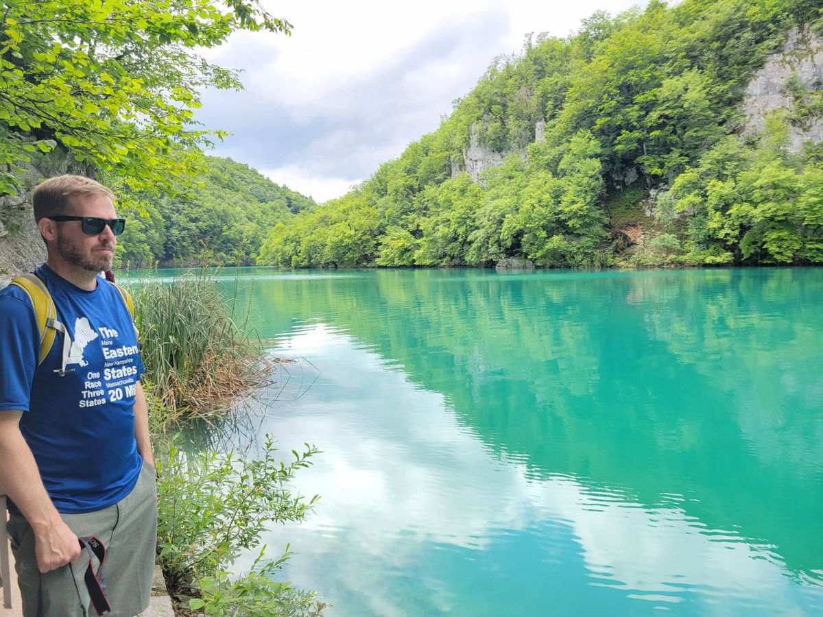 Brendan beside a turquoise lake