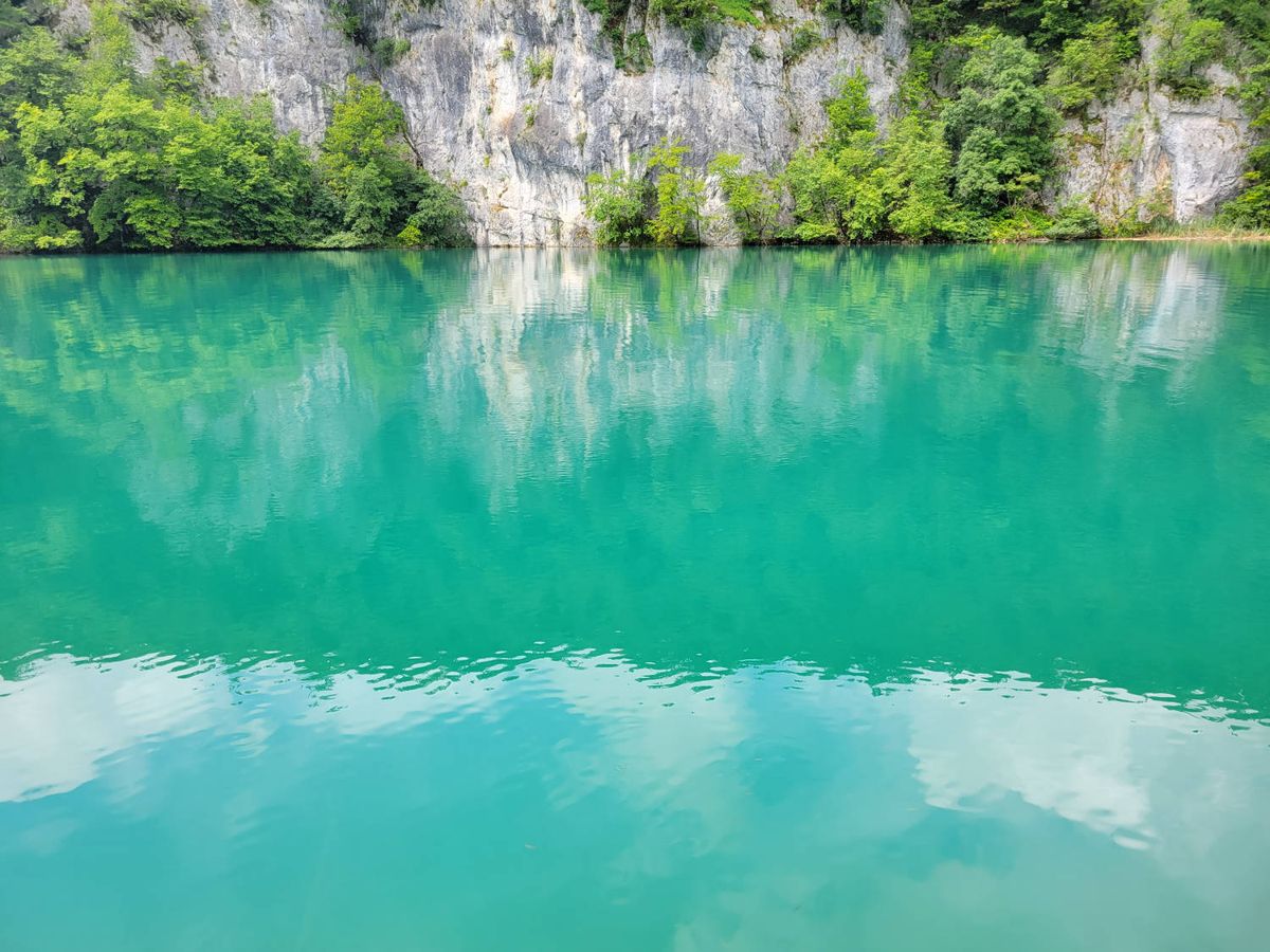 Cliffs reflected in turquoise water
