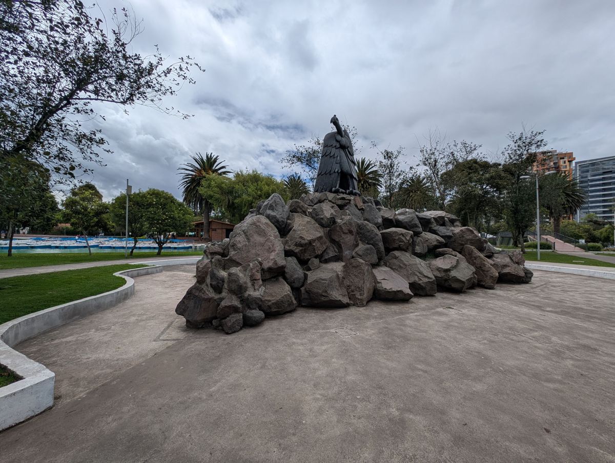 A black bird statue on a heap of boulders