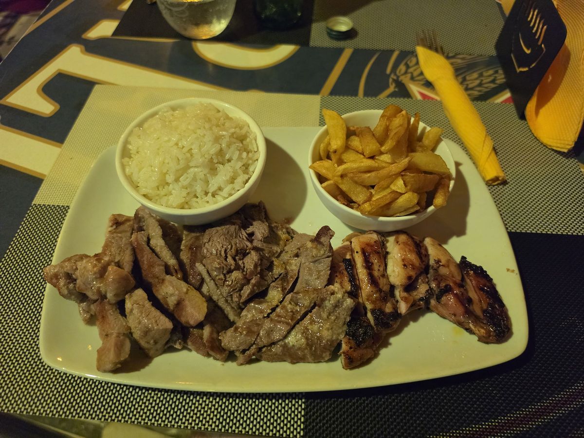 A mixed grill with rice and fries