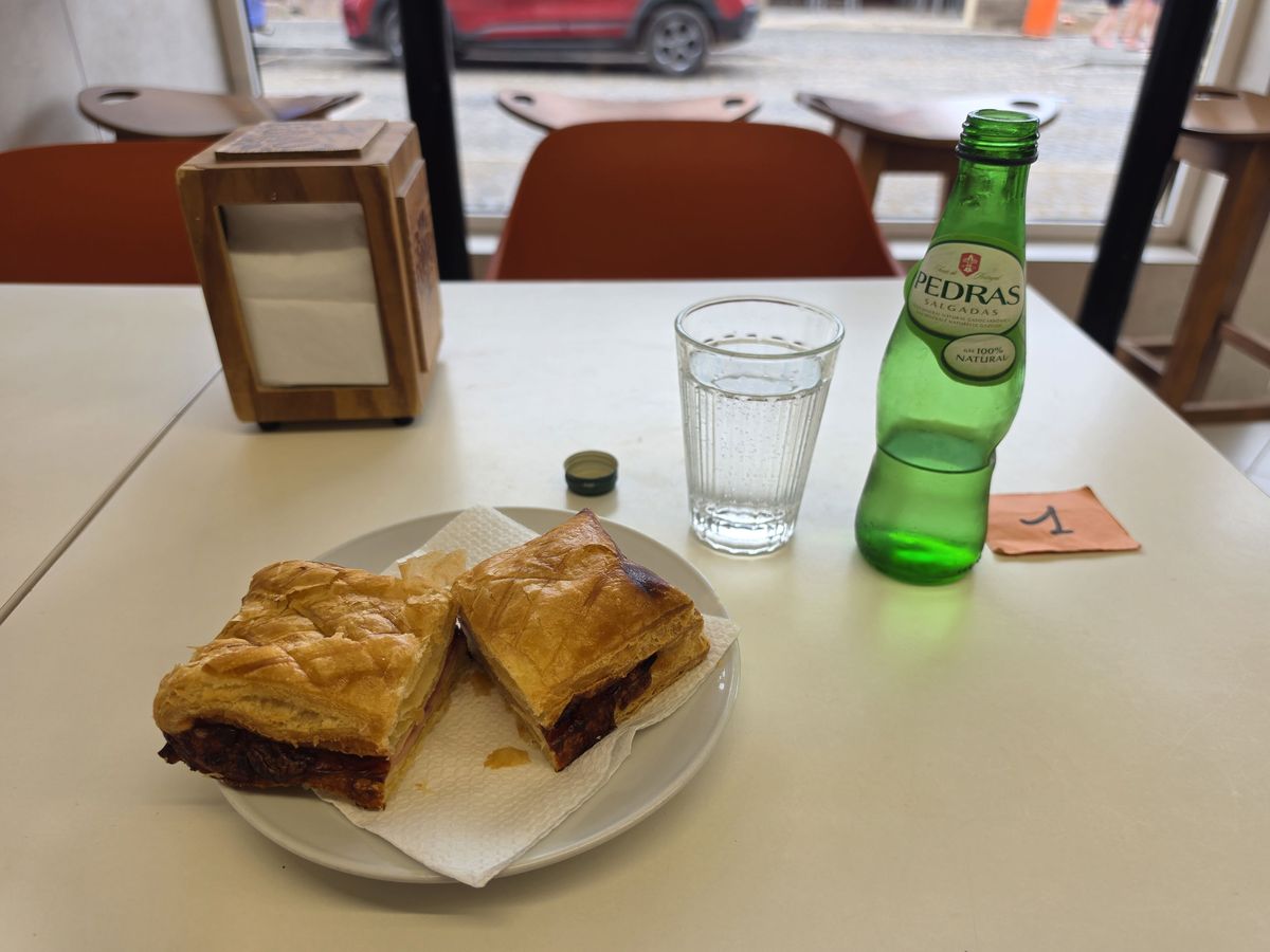 A ham and cheese pastry with Pedras sparkling water