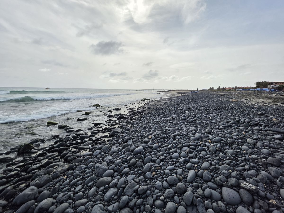 A beach of smooth black stones