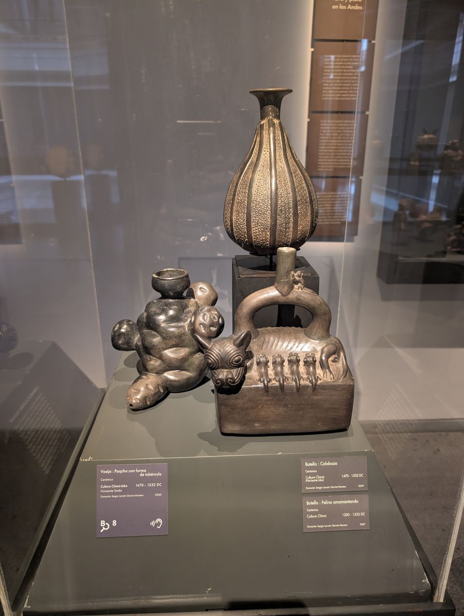 Chimú blackware: a tuber-shaped vessel, a gourd bottle, and a nursing feline
