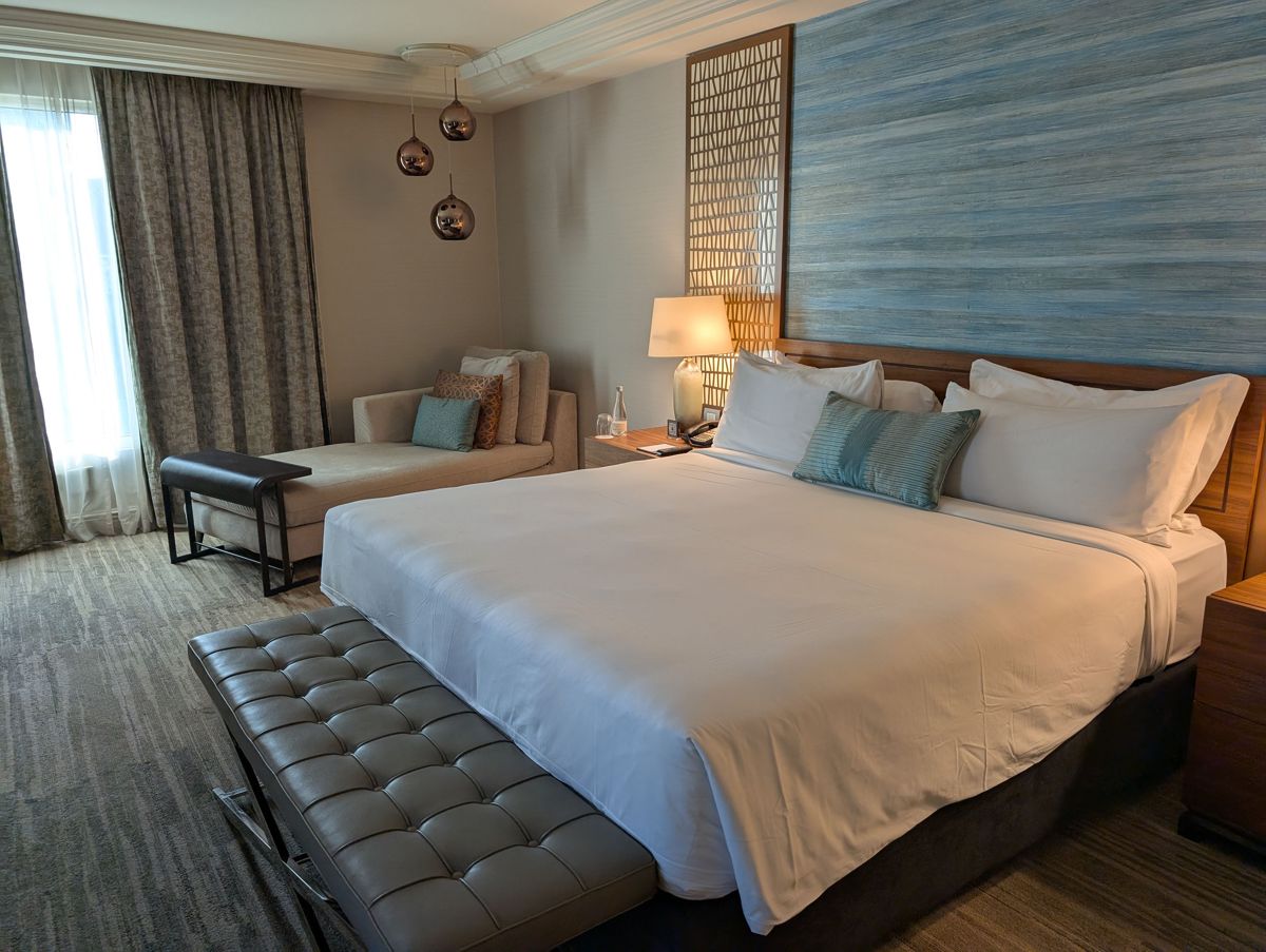 The bedroom, with a chaise by the window