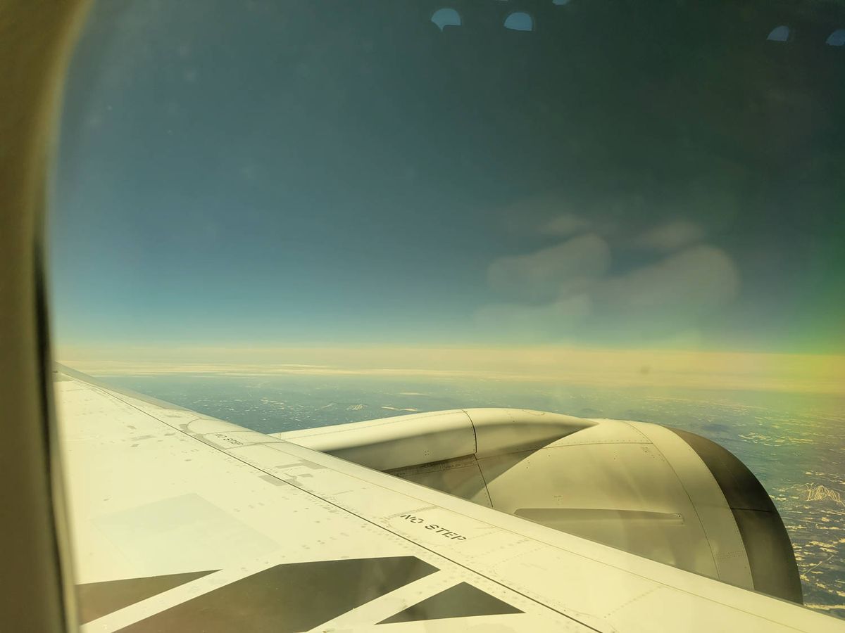 The wing over the clouds after takeoff