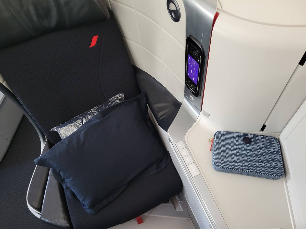 The seat with a pillow and the amenity kit